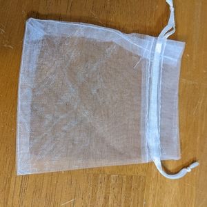 Small white mesh drawstring pouches